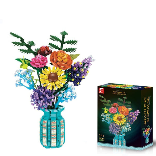 Colorful flower arrangement made of interlocking bricks with a matching box on a white background